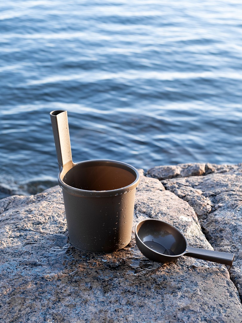 Orthex sauna bucket and sauna scoop on the rocks by the water